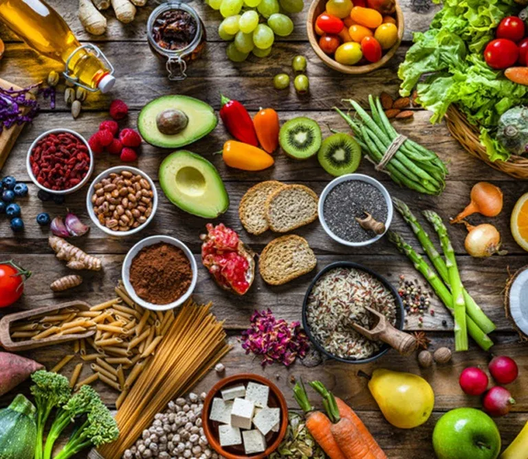 Fresh salmon fillets, avocado, grains, and green vegetables arranged neatly, demonstrating a clean diet that supports bladder function.